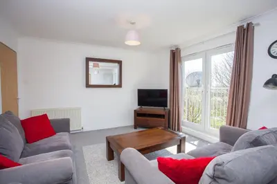 a living room with two couches and a television at 3 Bedroom Duplex with Free Parking in Glasgow