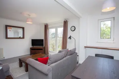 a living room with a couch and a table at 3 Bedroom Duplex with Free Parking in Glasgow