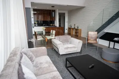 a living room with a couch and chairs and a piano at Stunning 3 Bed Penthouse in West End in Glasgow