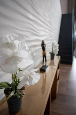 a table with white flowers and a figurine on it at Stunning 3 Bed Penthouse in West End in Glasgow
