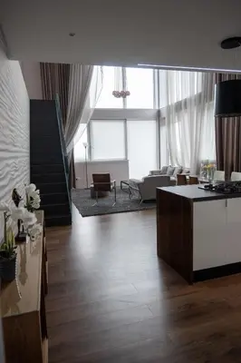 a large living room with a kitchen and a living room at Stunning 3 Bed Penthouse in West End in Glasgow