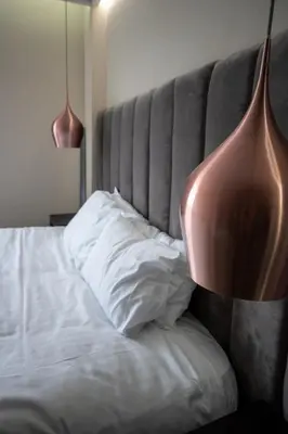 a bedroom with a bed with a vase on it at Stunning 3 Bed Penthouse in West End in Glasgow