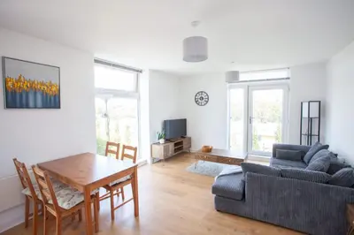 a living room with a table and a couch at Stylish Newly Decorated 2 Bed in Glasgow
