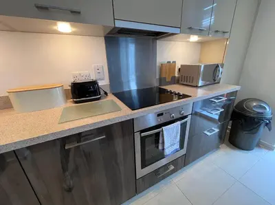 a kitchen with stainless steel appliances and a counter top at Stylish Newly Decorated 2 Bed in Glasgow