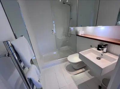 a bathroom with a toilet and a sink and a shower at Stylish Newly Decorated 2 Bed in Glasgow