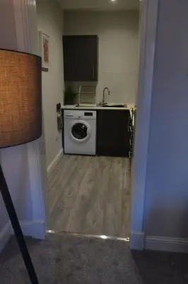a kitchen with a washing machine in a room at 2 Bedroom Oasis in Glasgow City Centre in Glasgow