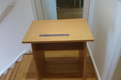 a small wooden table in a corner of a room at 2 Bedroom Oasis in Glasgow City Centre in Glasgow
