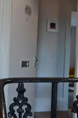 a hallway with a white door and a black railing at 2 Bedroom Oasis in Glasgow City Centre in Glasgow