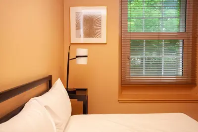 a bedroom with a bed and a window at Charming Sandstone-Basement Apartment in West End in Glasgow