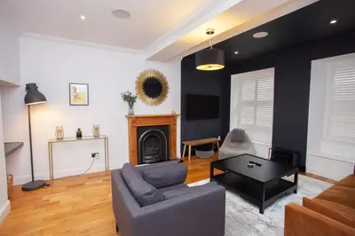 a living room with a couch and a table at Charming Sandstone-Basement Apartment in West End in Glasgow