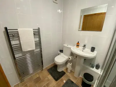 a bathroom with a toilet and a sink and a mirror at Pure East Coast Trainline by TBA in Fife