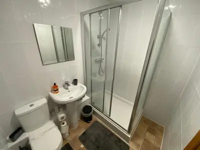 a bathroom with a shower and a toilet and a sink at Pure East Coast Trainline by TBA in Fife