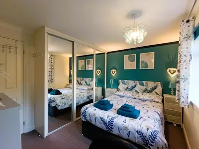 a bedroom with two beds and a mirror at Double Room in Riverside Apartment - C in Glasgow