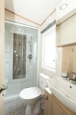 a bathroom with a toilet and a shower and a sink at Lochgilphead Caravan Park in Lochgilphead