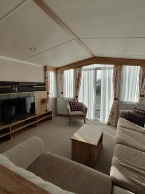 a living room with a couch and a tv at Lochgilphead Caravan Park in Lochgilphead