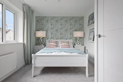 a bedroom with a white bed with two lamps at 3BDR House By Vista Stays Short Lets & Serviced Accommodation Glasgow Scotland With Driveway Parking and PS4 in Glasgow