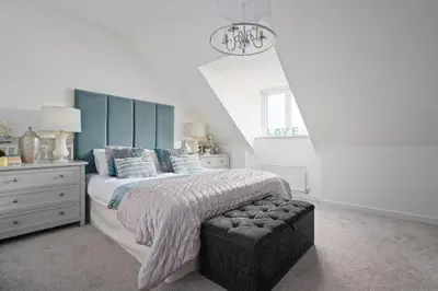 a bedroom with a large bed with a blue headboard at 3BDR House By Vista Stays Short Lets & Serviced Accommodation Glasgow Scotland With Driveway Parking and PS4 in Glasgow