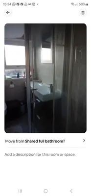 a bathroom with a sink and a mirror at Garden homely house in Cardonald
