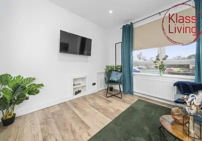 a living room with a tv and a table at Drumpellier Apartment by Klass Living Coatbridge in Coatbridge