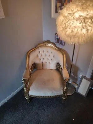 a chair sitting next to a lamp in a room at Gadsby manor in Drumchapel