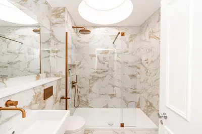 a white bathroom with a tub and a sink at Dragon Suites Luxury Apartments at 9 Albyn Place in Edinburgh