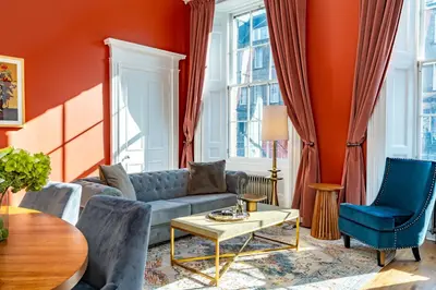 a living room with a couch and chairs at Dragon Suites Luxury Apartments at 9 Albyn Place in Edinburgh