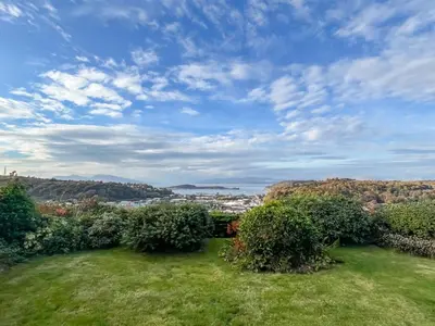 a view of a field of grass and bushes at Kiloran in Oban