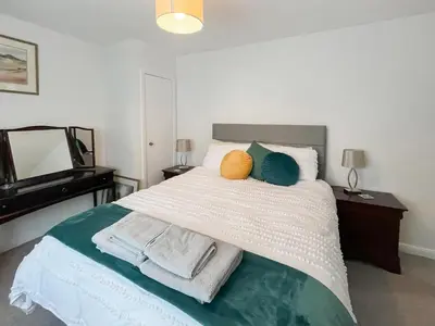a bedroom with a bed with towels and a piano at Kiloran in Oban