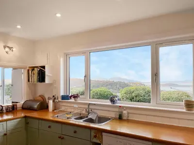 a kitchen with a sink and a window with a view at Kiloran in Oban