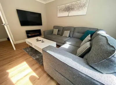 a living room with a couch and a table at Central two bedroom, Free private parking in Glasgow