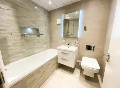 a bathroom with a toilet and a tub and a sink at Central two bedroom, Free private parking in Glasgow