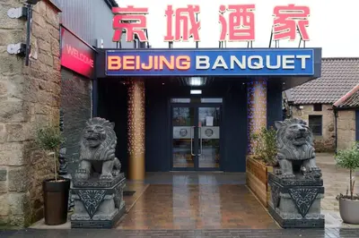 a building with two lion statues in front of it at Kelpies Hotel Falkirk in Falkirk
