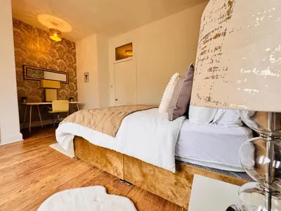 a bedroom with a large bed and a desk at THE RESTING LION - Gourock Town Center Holiday Home Apartment in Gourock