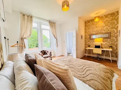 a living room with a couch and a table at THE RESTING LION - Gourock Town Center Holiday Home Apartment in Gourock