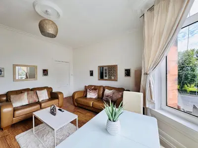 a living room with a couch and a table at THE RESTING LION - Gourock Town Center Holiday Home Apartment in Gourock