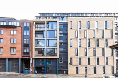 an apartment building with many windows on a street at For Students Only Portsburgh Court Edinburgh in Edinburgh