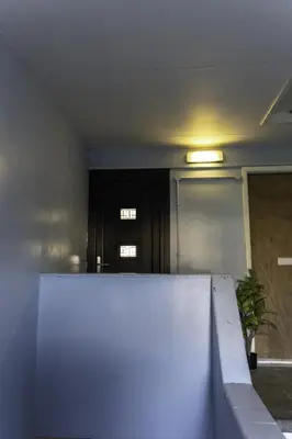 a room with a white wall and a door at Dunbank Apartment in Clydebank