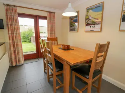 a dining room with a wooden table and chairs at The Stables at Daldorch in Mauchline