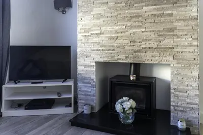 a living room with a fireplace and a tv at 3 BDR House By Caledonia Luxe Stays Short Lets & Serviced Accommodation Airdrie in Airdrie