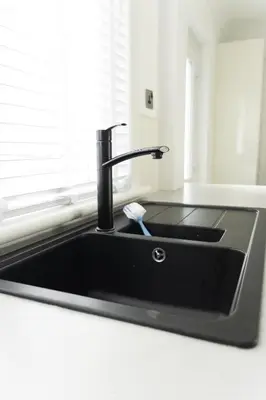 a black kitchen sink with a toothbrush in it at 3 BDR House By Caledonia Luxe Stays Short Lets & Serviced Accommodation Airdrie in Airdrie