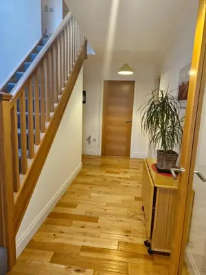 a hallway with wooden floors and a staircase at Beolary in Oban