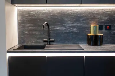 a kitchen sink with a faucet and a candle at The Fairlie Suite No2 in Prestwick