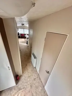 an empty room with a door and a hallway at Delta, Bromley 4-Bedroom Located in Uddingston, Glasgow at Maryville Caravan Site in Uddingston