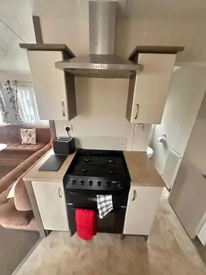 a kitchen with a stove top oven in a room at Delta, Bromley 4-Bedroom Located in Uddingston, Glasgow at Maryville Caravan Site in Uddingston
