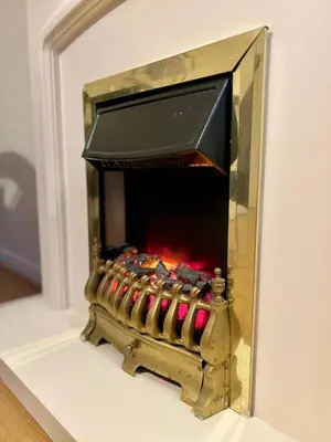 a fireplace with a fire inside of it at Charming, Cosy Escape with Quick Access to Glasgow in Paisley