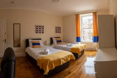 a bedroom with two beds and a window at 3 Bedroom Apartment with castle views in Edinburgh
