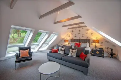 a living room with a couch and two chairs at Invercreran House in Appin