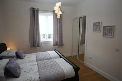 a bedroom with a bed and a window at Edinburgh Pearl Apartments - Dalry House Residence in Edinburgh
