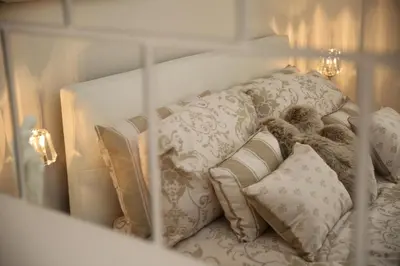a stuffed teddy bear sitting on a bed with pillows at Edinburgh Pearl Apartments - Dalry House Residence in Edinburgh