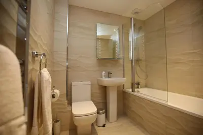 a bathroom with a toilet and a sink and a shower at Edinburgh Pearl Apartments - Dalry House Residence in Edinburgh